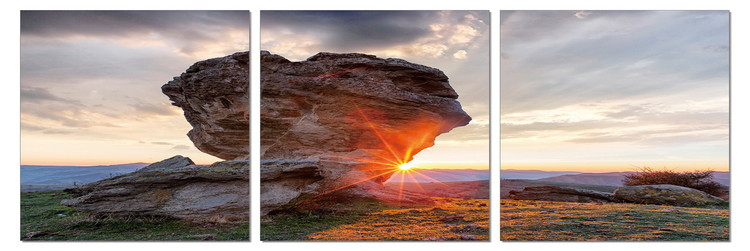Sun setting behind a rock Modern tavla