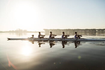 Poster Mixed race rowing team training on a lake at dawn