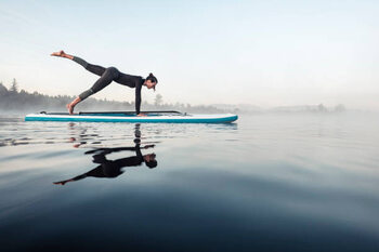 Poster Woman practicing paddle board yoga on