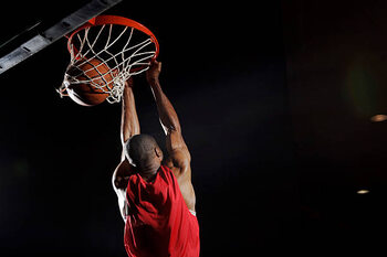 Художествена фотография Man dunking basketball