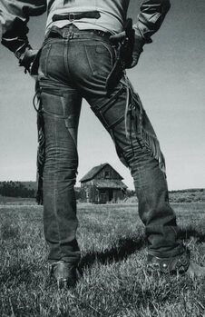 Obraz na plátně Cowboy Standing near Old Home