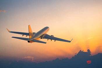 Plakát Passenger airplane flying above clouds during