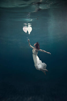 Poster girl underwater with balloons