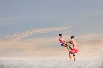Póster Young sporty couple practicing acroyoga exercises