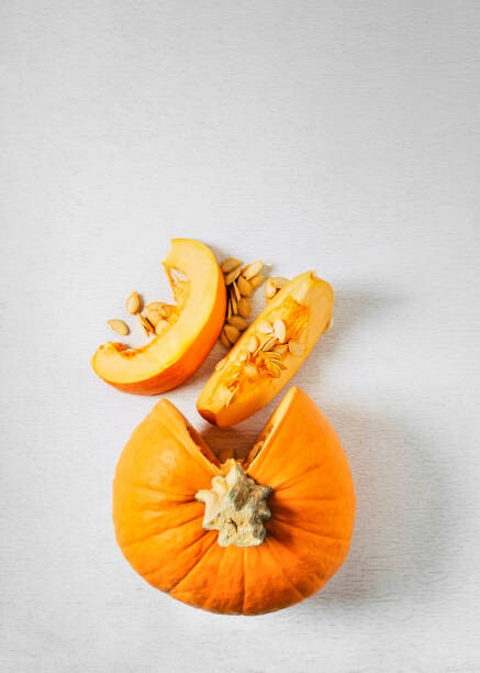 Levně Plakát, Obraz - Sliced pumpkin on white background, Claudia Totir, 30 × 40 cm