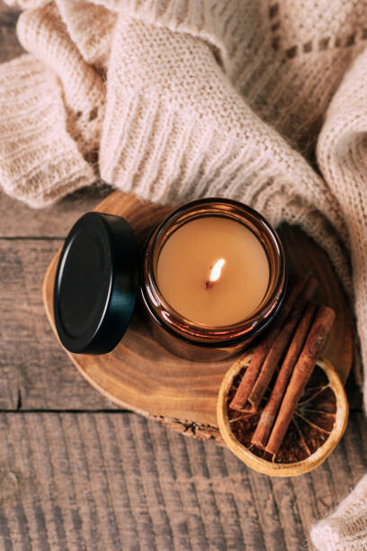 Plakát, Obraz - Candle in small amber glass jar with wooden wick on wooden stand on background. Top view, Alexandr Kolesnikov, 26.7 × 40 cm