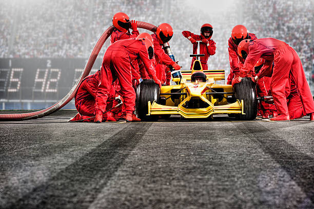 Levně Plakát, Obraz - Pit Crew Servicing open-wheel single-seater racing, David Madison, 40 × 26.7 cm