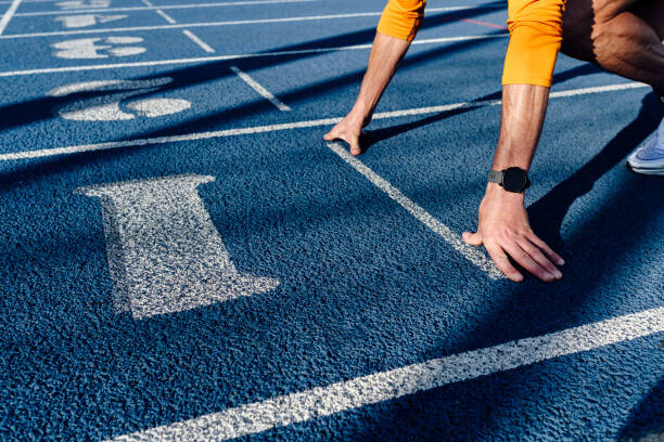 Levně Plakát, Obraz - Sportsman at starting line of running track, Westend61, 40 × 26.7 cm