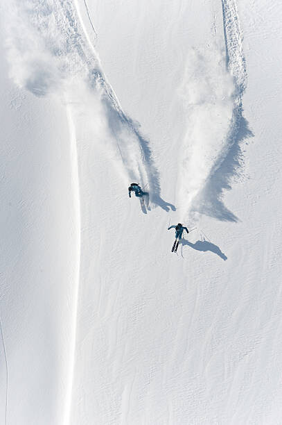 Fotografie Aerial view of two skiers skiing, Creativaimage, 26.7x40 cm