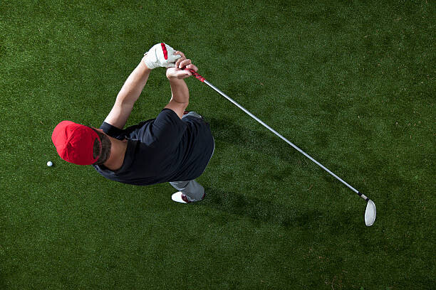 Levně Plakát, Obraz - A golfer swinging a golf club, overhead view, fStop Images - Halfdark, 40 × 26.7 cm