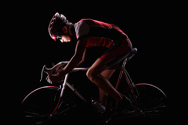 Levně Plakát, Obraz - cyclist on black background, Stanislaw Pytel, 40 × 26.7 cm