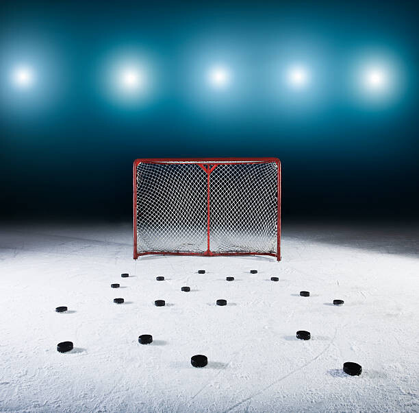 Levně Plakát, Obraz - Ice hockey goal surrounded by pucks., Robert Decelis, 40 × 40 cm
