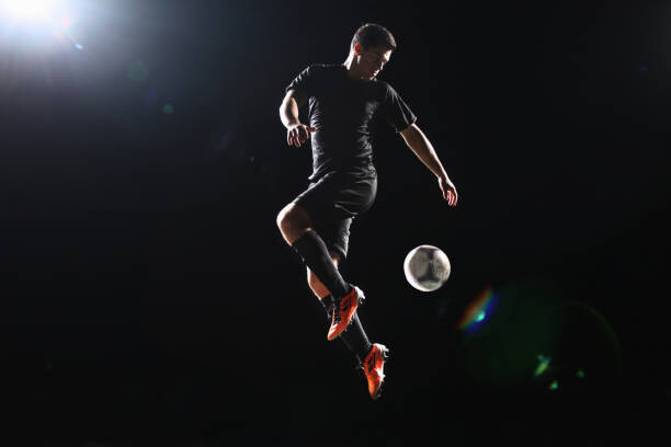 Levně Plakát, Obraz - Football player jumping with ball on, Stanislaw Pytel, 40 × 26.7 cm