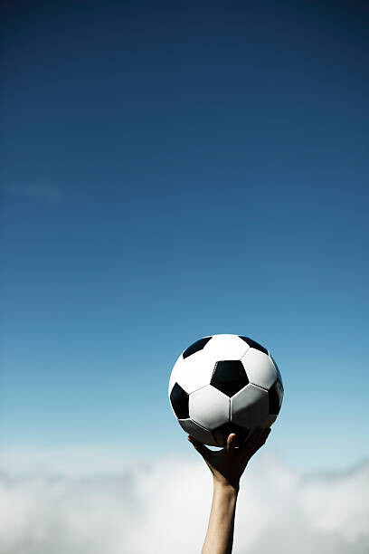 Levně Plakát, Obraz - Woman's Hand with a soccer ball, RunPhoto, 26.7 × 40 cm