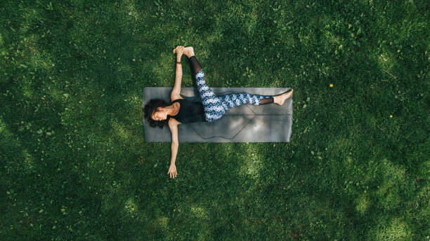 Levně Plakát, Obraz - Woman doing Yoga in the Park, GabrielPevide, 40 × 22.2 cm