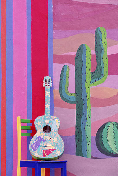 Levně Plakát, Obraz - PAINTED GUITAR, CHAIR & WALL IN CANCUN, MEXICO, Grant Faint, 26.7 × 40 cm