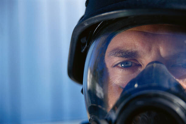 Levně Plakát, Obraz - Police Officer Wearing Gas Mask, Rick Barrentine, 40 × 26.7 cm