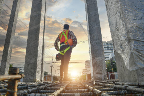 Levně Plakát, Obraz - Working at height equipment on during sunset, Cavan Images, 40 × 26.7 cm