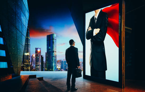 Levně Plakát, Obraz - Young businessman looking the hero businessman, jamesteohart, 40 × 26.7 cm