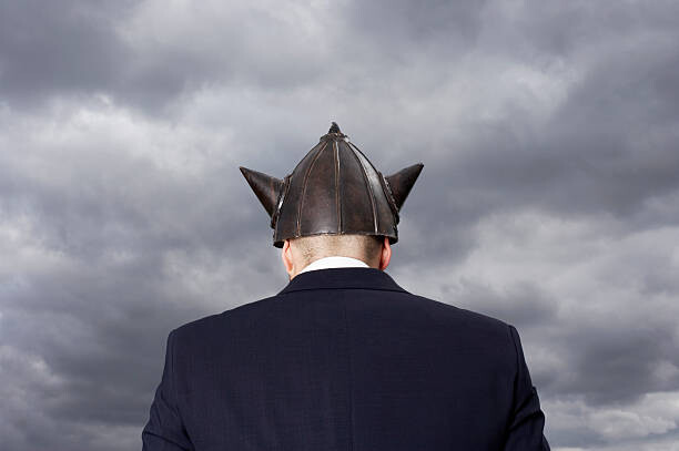 Levně Plakát, Obraz - Man wearing metal 'Viking' helment, rear view, Tim Robberts, 40 × 26.7 cm