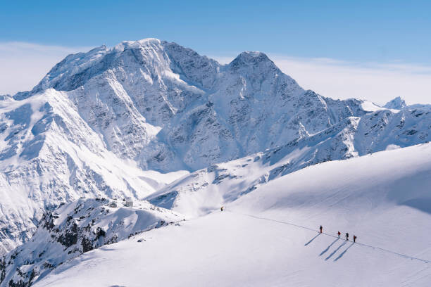 Levně Plakát, Obraz - Ski mountaineers advance towards mountain summit, Milo Zanecchia/ Ascent Xmedia, 40 × 26.7 cm