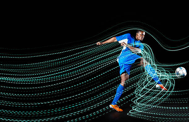 Plakát, Obraz - Football/ soccerplayer with lighttrace, Henrik Sorensen, 40 × 26.7 cm