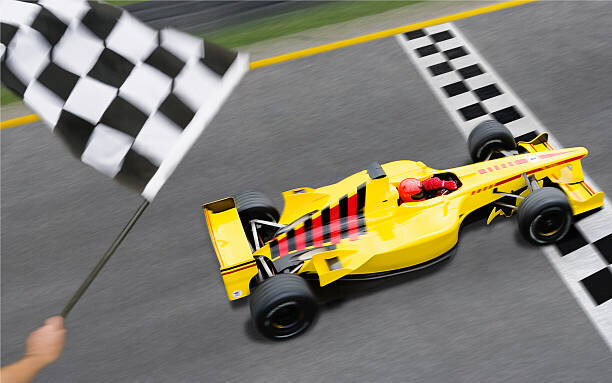 Levně Plakát, Obraz - Checkered Flag Waving as Racecar Crosses, David Madison, 40 × 26.7 cm