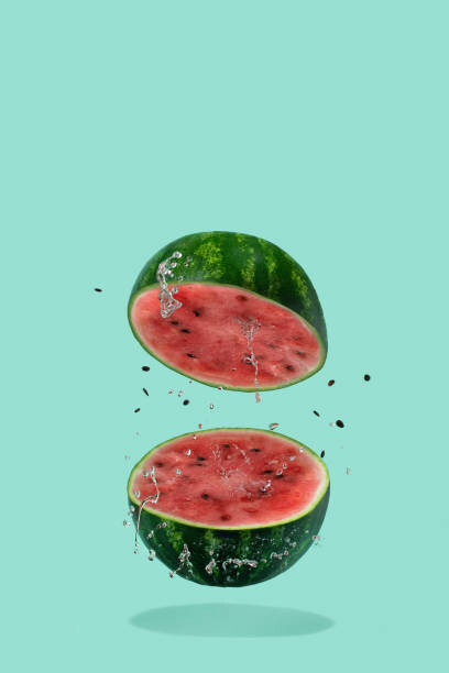 Levně Plakát, Obraz - Watermelon sliced flying on pastel green, Amax Photo, 26.7 × 40 cm
