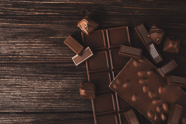 Levně Plakát, Obraz - Chocolate bars with nuts and candies close-up., Olena Ruban, 40 × 26.7 cm