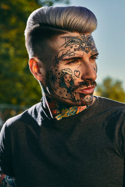 Fotografie Portrait of tattooed young man outdoors, Westend61, (26.7 x 40 cm)
