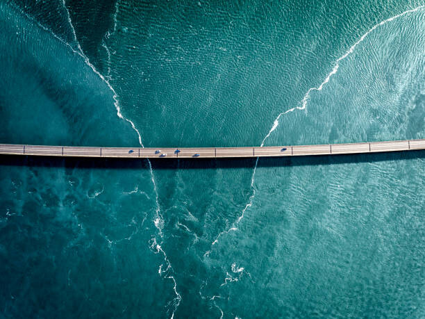 Fotografie Driving on a bridge over deep blue water, HRAUN, 40x30 cm