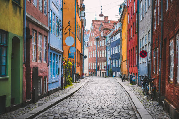 Fotografie Narrow cobblestone alley with colorful houses, © Marco Bottigelli, 40 × 26.7 cm