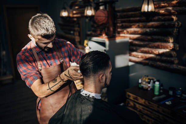 Levně Plakát, Obraz - One hairdresser cutting hair of a, South_agency, 40 × 26.7 cm