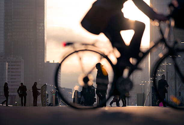 Poster Businessman on bicycle passing skyline La Defense