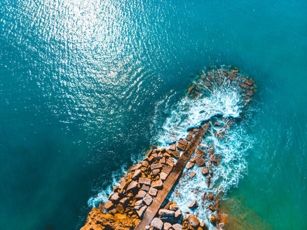 Poster dramatic waves at breakwaters from the bird view