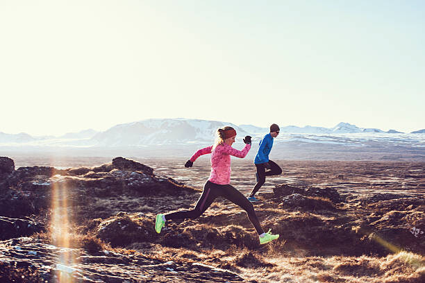 Poster Male and Female free running through mountains