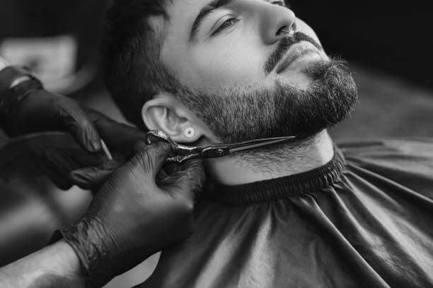 Poster Professional hairdresser working with bearded client