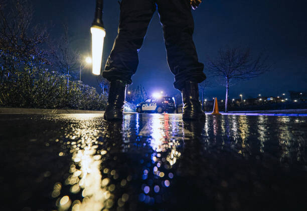 Poster Unrecognizable police officers in rainy night