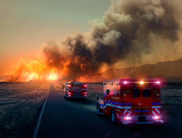 Umělecká fotografie Ambulance driving to forest fire in desert