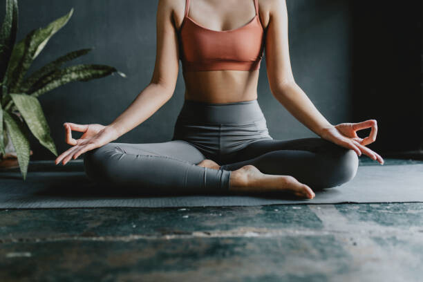 Művészeti fotózás Anonymous Woman Doing Yoga at Home: Lotus Position