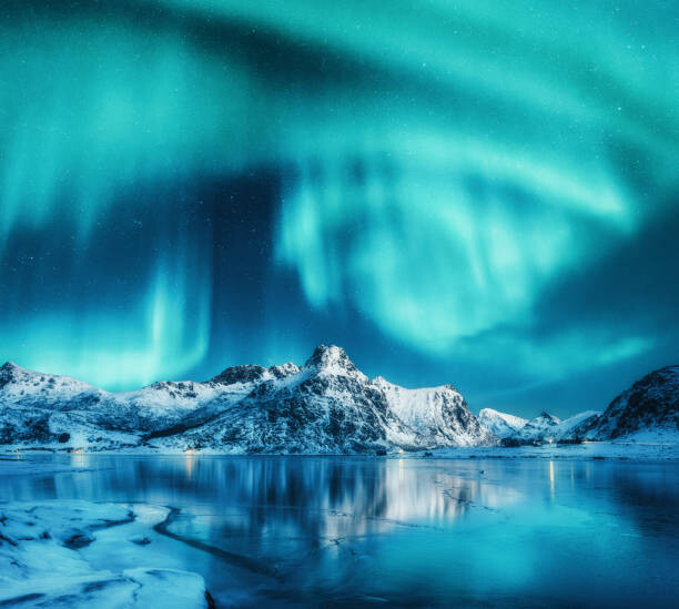 Художествена фотография Aurora borealis above snowy mountains, frozen