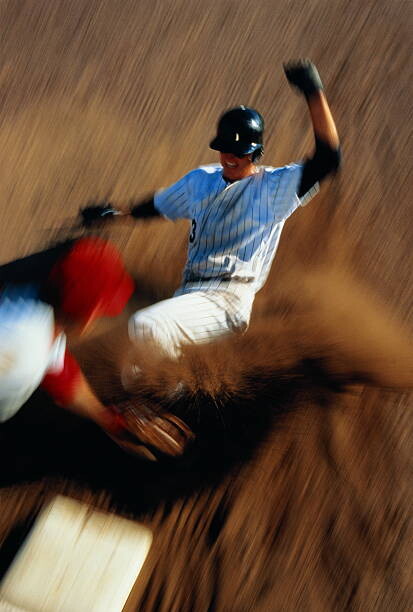 Konstfotografering Baseball, player sliding into third base