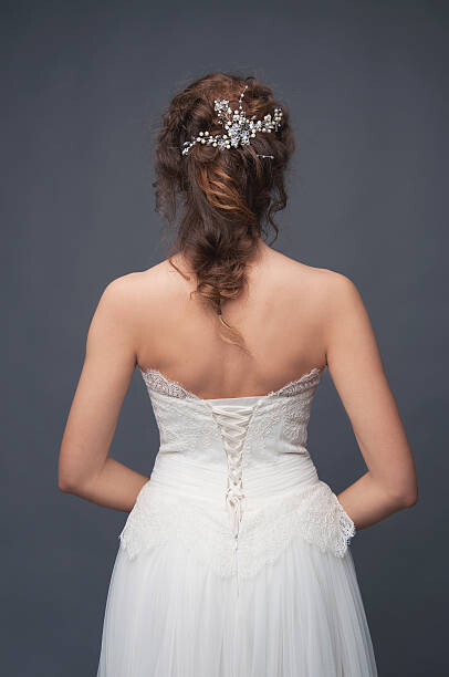 Fotografie de artă Bridal fashion. Brunette bride view from the back.