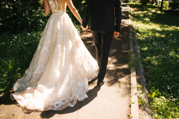 Fotografie Bride and groom walking on pavements