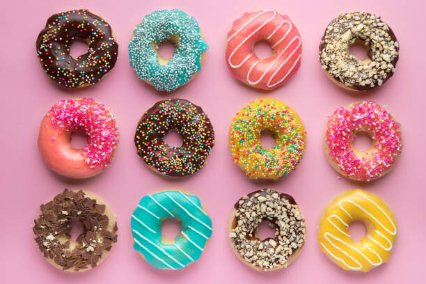 Kunstfotografie Colorful sweet background. Delicious glazed donuts