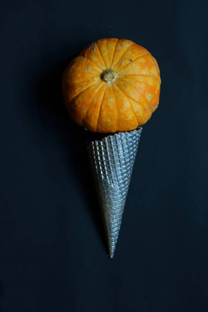 Umjetnička fotografija Cream cone with pumpkin. Halloween concept