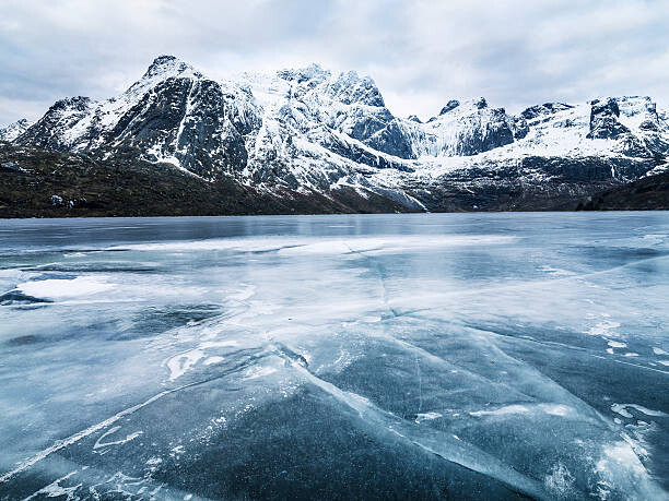 Художествена фотография Frozen water and mountain range on background