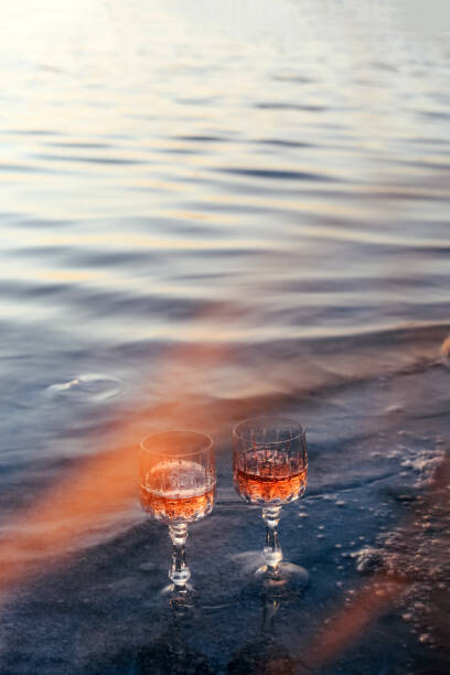 Kunstfotografie Glasses of champagne on the beach. Alcoholic drink outdoors. Unusual drink.