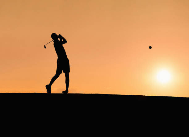 Művészeti fotózás Golf player hitting the perfect pitch at sunset
