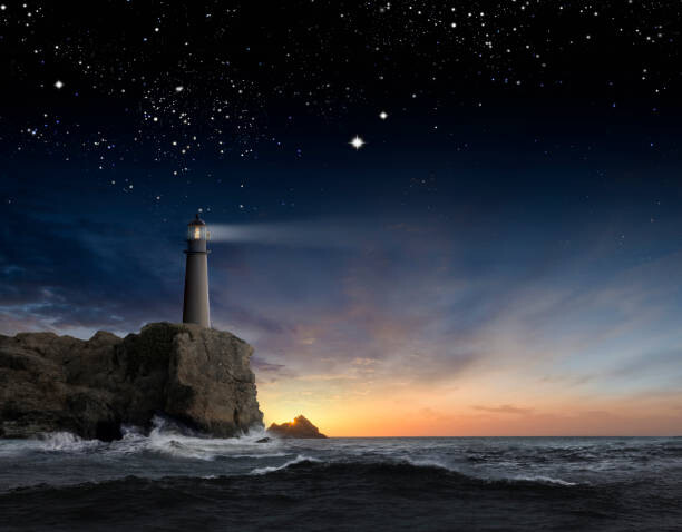 Umělecká fotografie Lighthouse beaming over rocky ocean waves